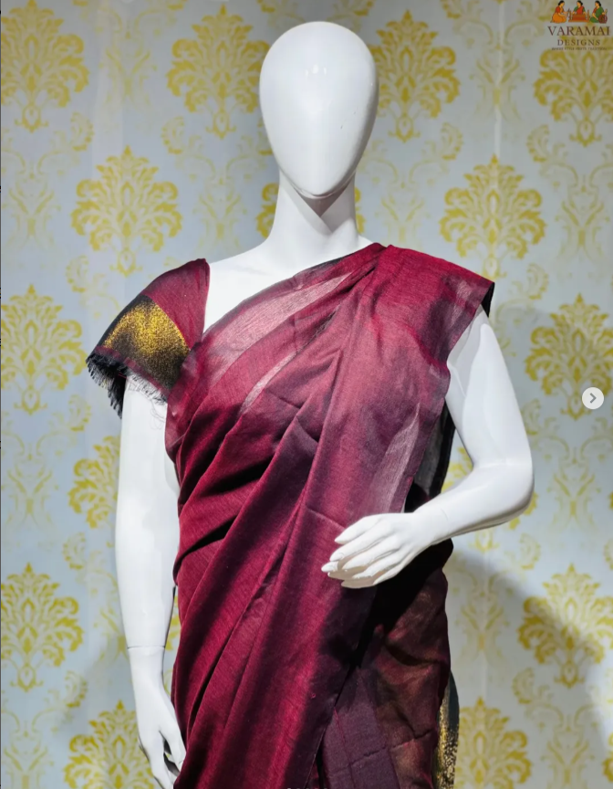 in a rich wine shade with a shimmering golden zari pallu